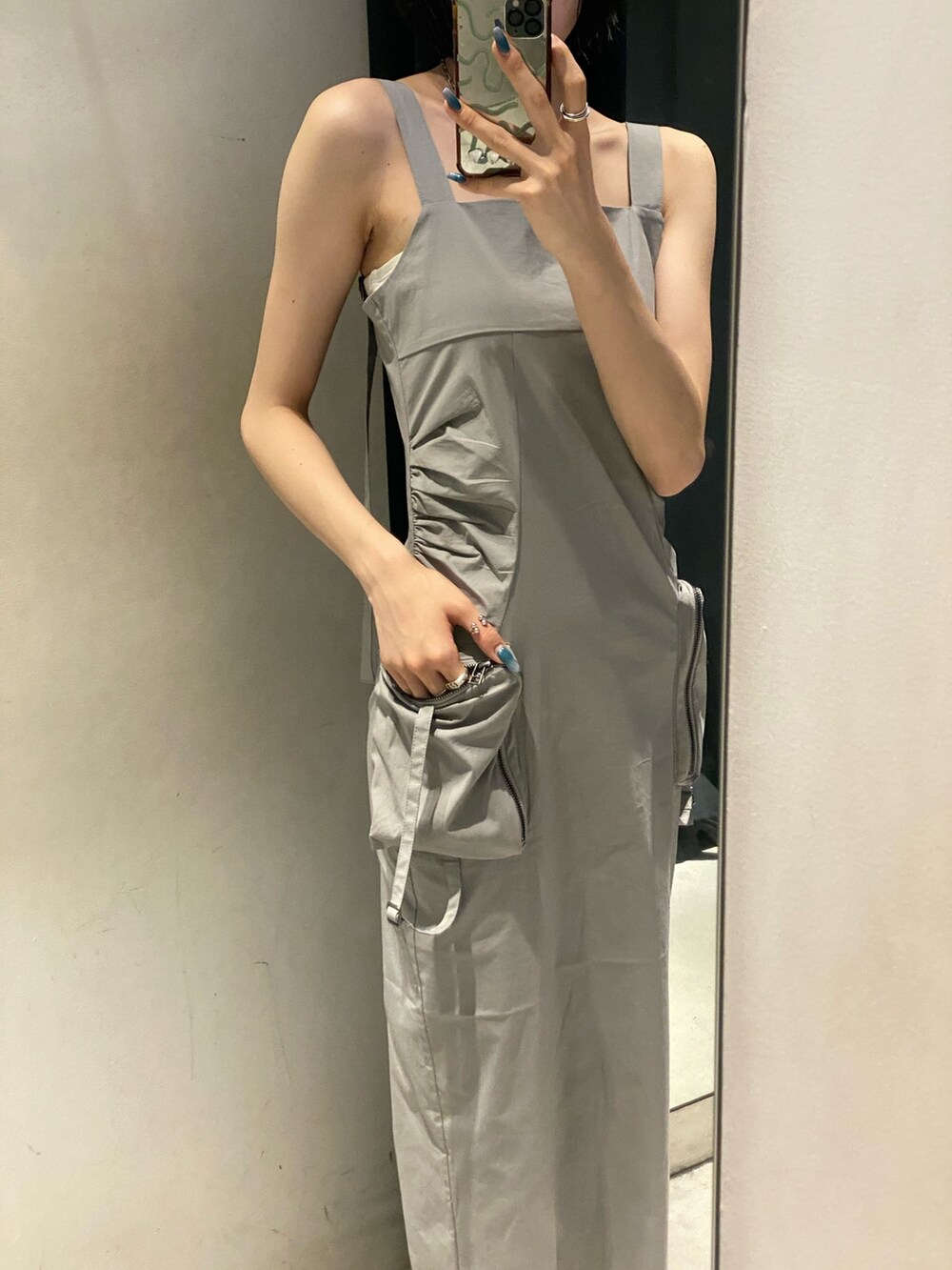 グレー系のワンピース、ブラック系のサンダル、ホワイト系のキャミソールを着用したレディースの夏コーディネートの6枚目の写真