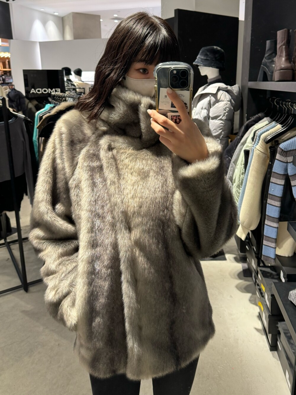 ブラック系のブーツ、ブラック系のデニムパンツ、グレー系のその他アウターを着用したレディースの冬コーディネートの5枚目の写真