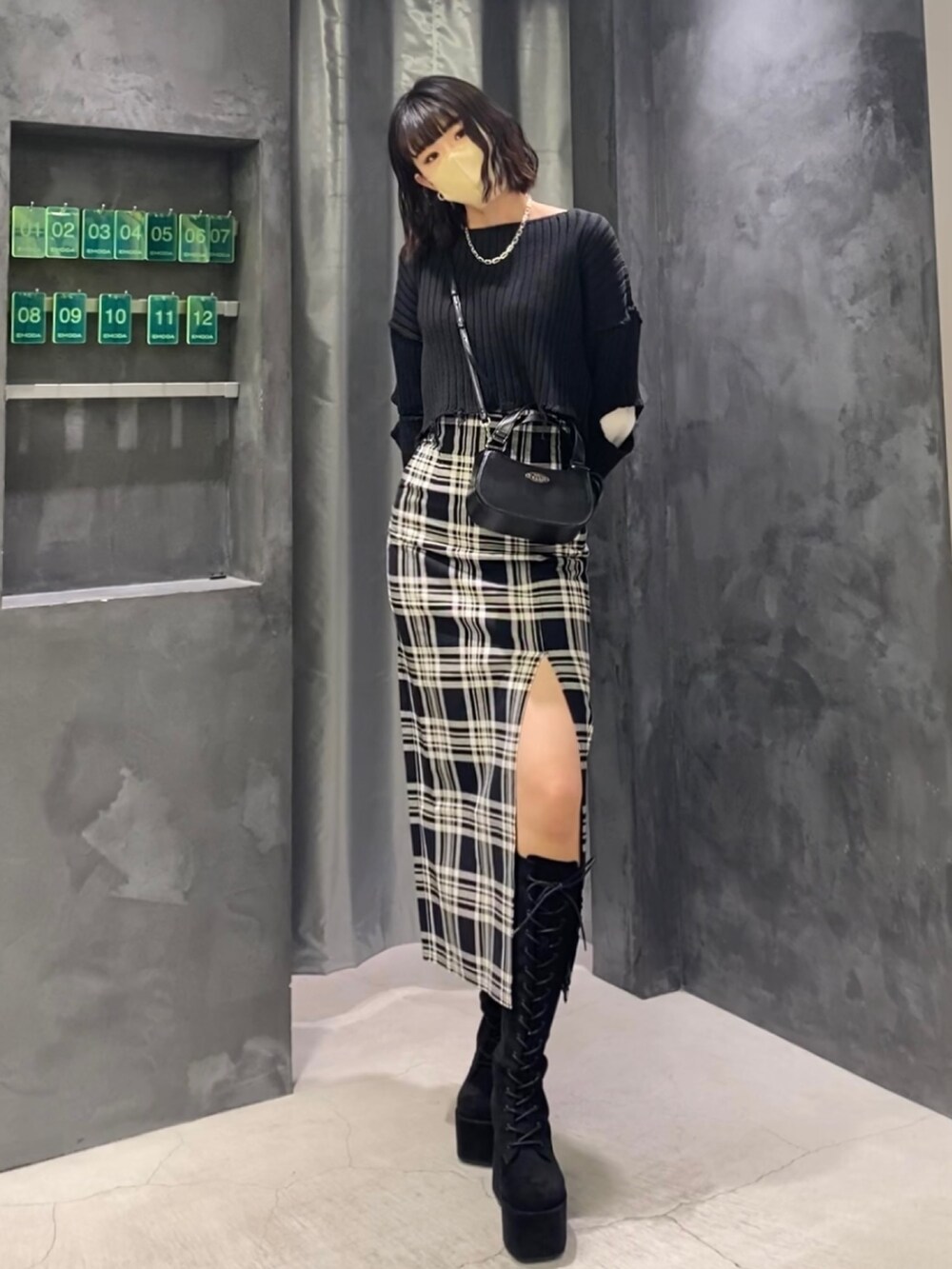 ブラック系のブーツ、その他のスカート、ブラック系のニット/セーターを着用したレディースの冬コーディネートの2枚目の写真