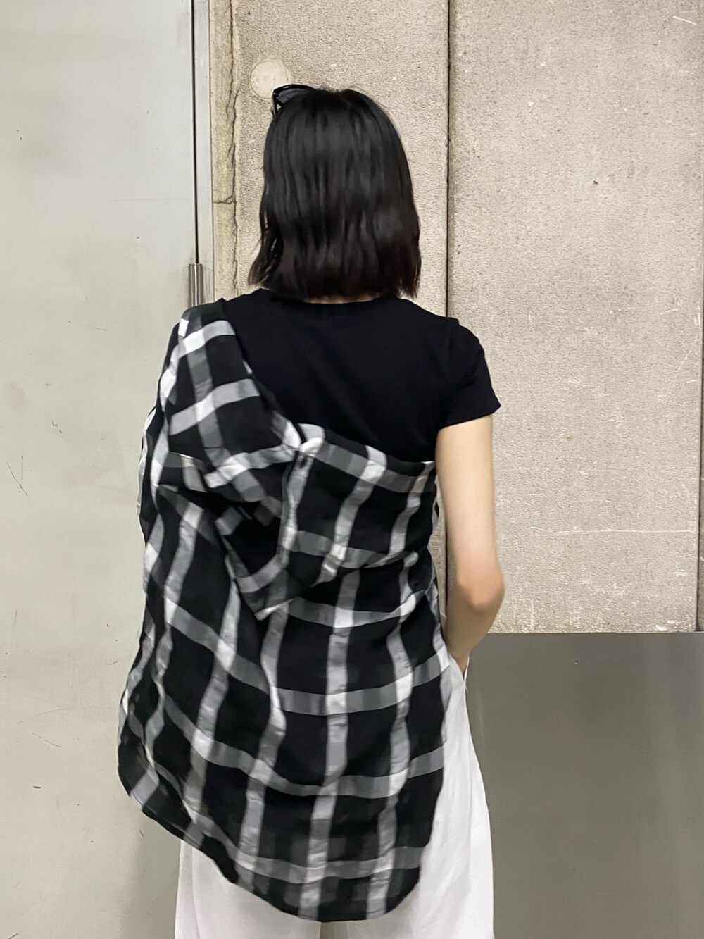 ホワイト系のその他パンツ、ブラック系のブーツ、ブラック系のTシャツ/カットソーを着用したレディースの春コーディネートの9枚目の写真