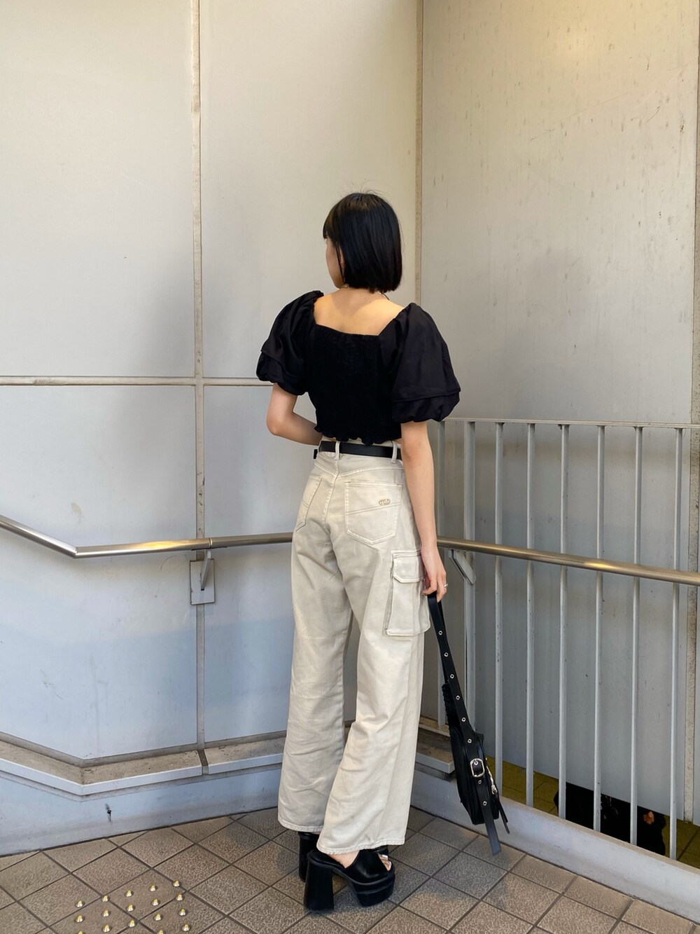 ブラック系のサンダル、ホワイト系のデニムパンツ、ブラック系のシャツ/ブラウスを着用したレディースの春コーディネートの7枚目の写真