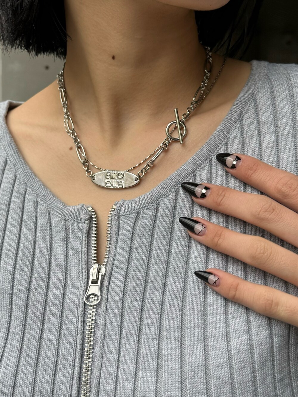 ブラック系のブーツ、ブラック系のデニムパンツ、グレー系のニット/セーターを着用したレディースの冬コーディネートの9枚目の写真