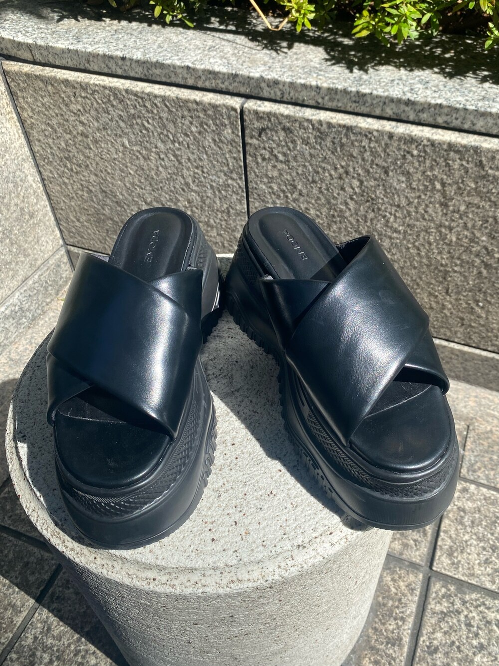 ブラック系のサンダル、ブルー系のデニムパンツ、ホワイト系のタンクトップを着用したレディースの夏コーディネートの9枚目の写真