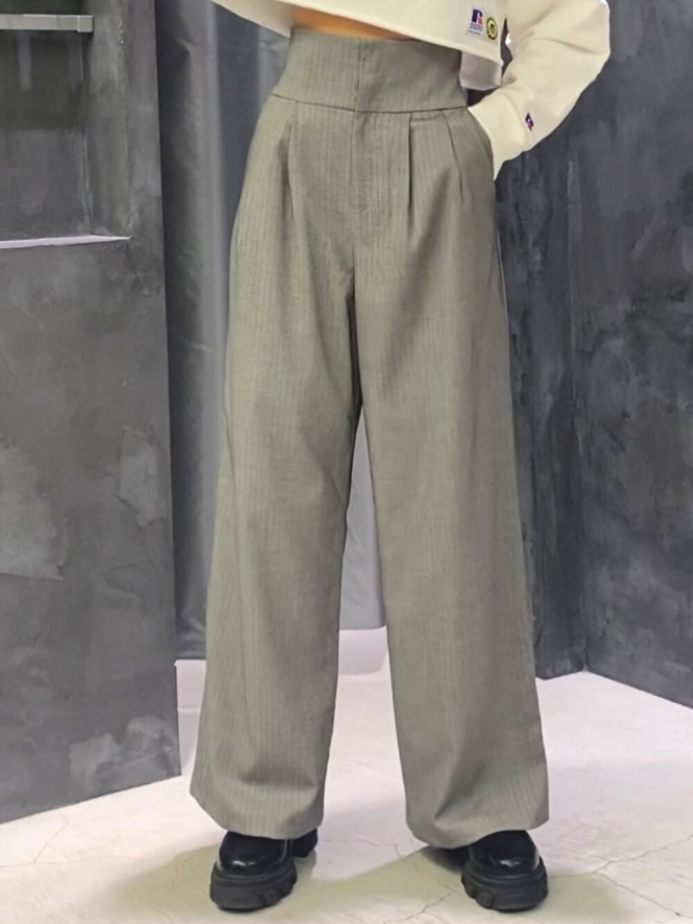 ブラック系のブーツ、グレー系のその他パンツ、ホワイト系のパーカーを着用したレディースの冬コーディネートの7枚目の写真