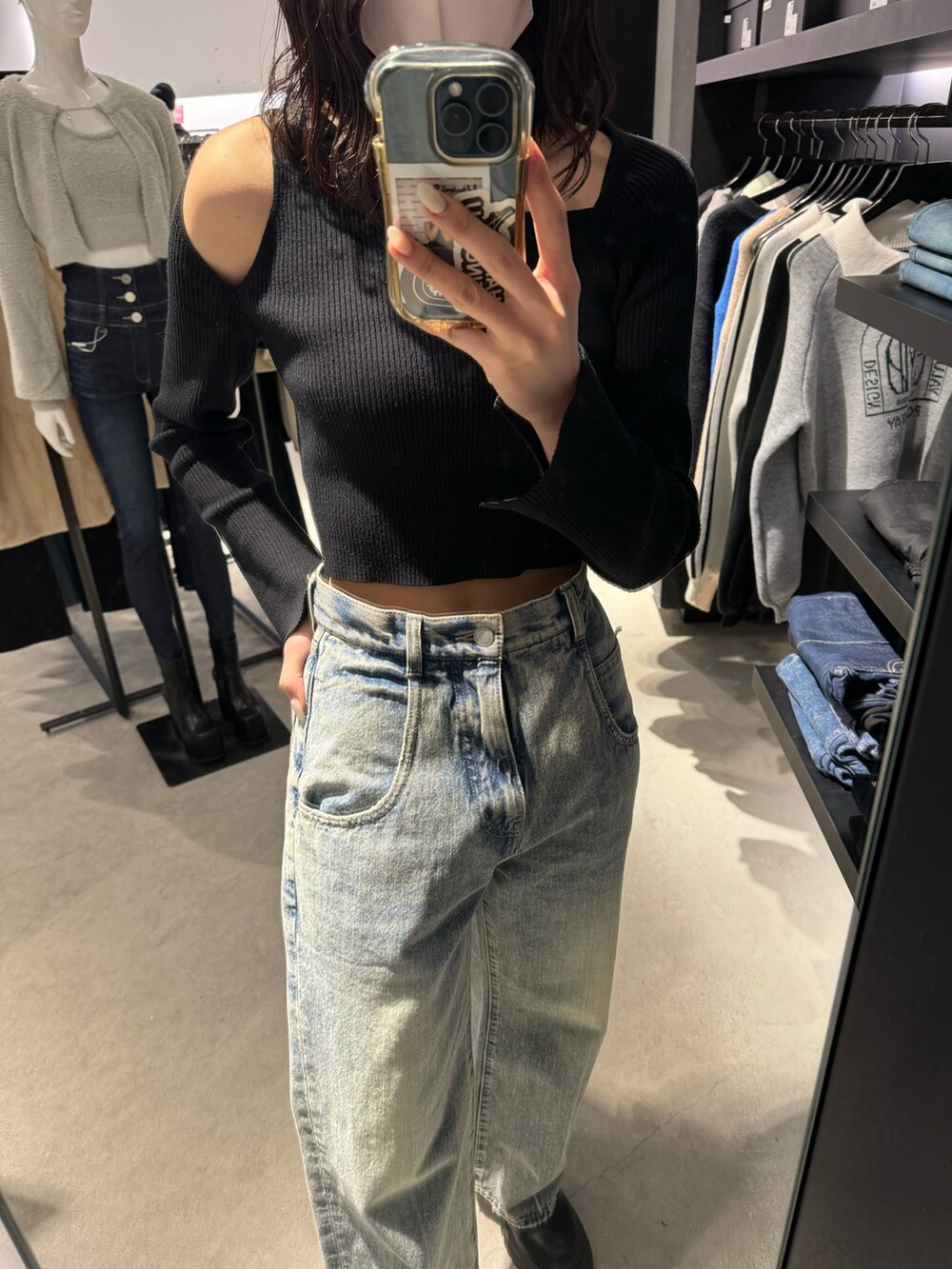 ブラック系のブーツ、ブルー系のデニムパンツ、ブラック系のニット/セーターを着用したレディースの冬コーディネートの5枚目の写真