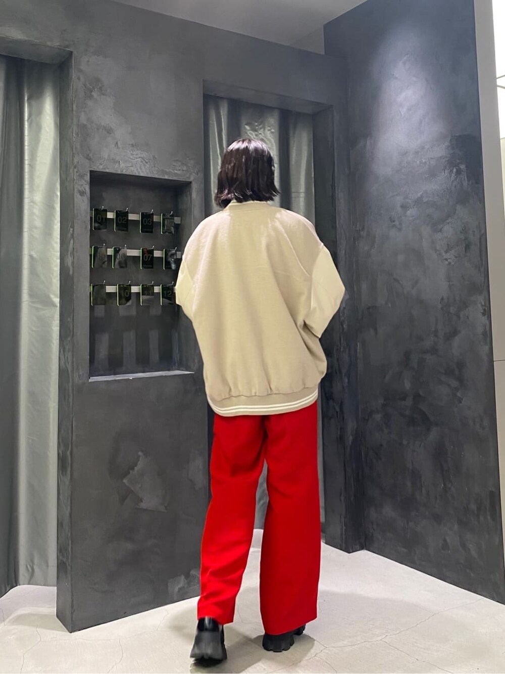 ホワイト系のブルゾン、ブラック系のローファー、レッド系のその他パンツを着用したレディースの秋コーディネートの5枚目の写真