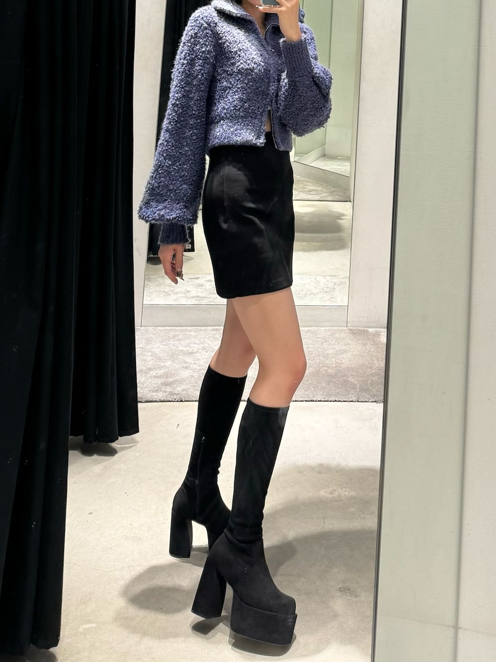 その他のブーツ、ブラック系のスカート、ブルー系のニット/セーターを着用したレディースの秋コーディネートの2枚目の写真