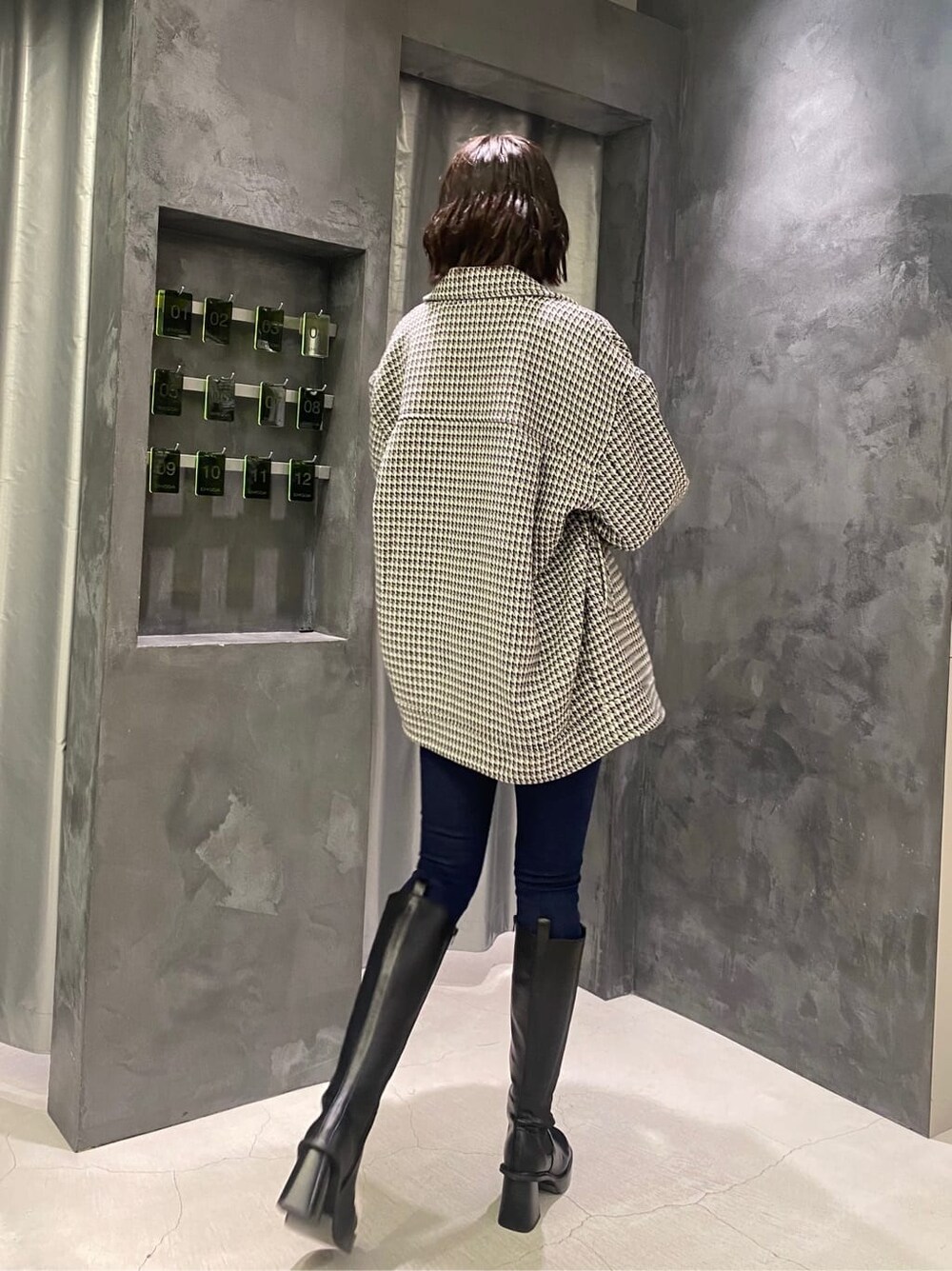 ブラック系のブーツ、その他のテーラードジャケット、ブルー系のデニムパンツを着用したレディースの秋コーディネートの4枚目の写真