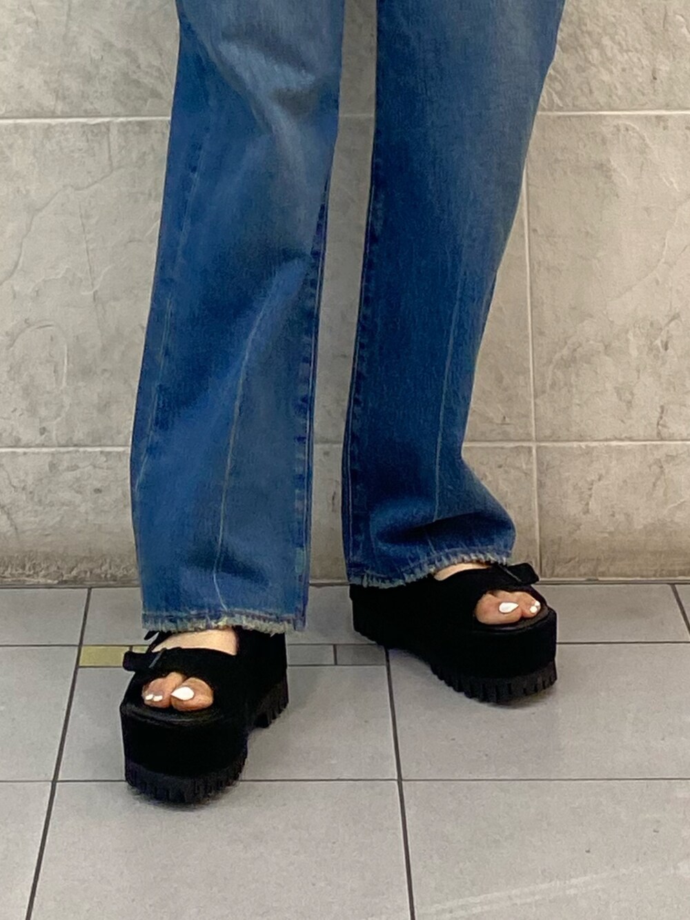 ブラック系のサンダル、ブルー系のデニムパンツ、ホワイト系のニット/セーターを着用したレディースの夏コーディネートの10枚目の写真