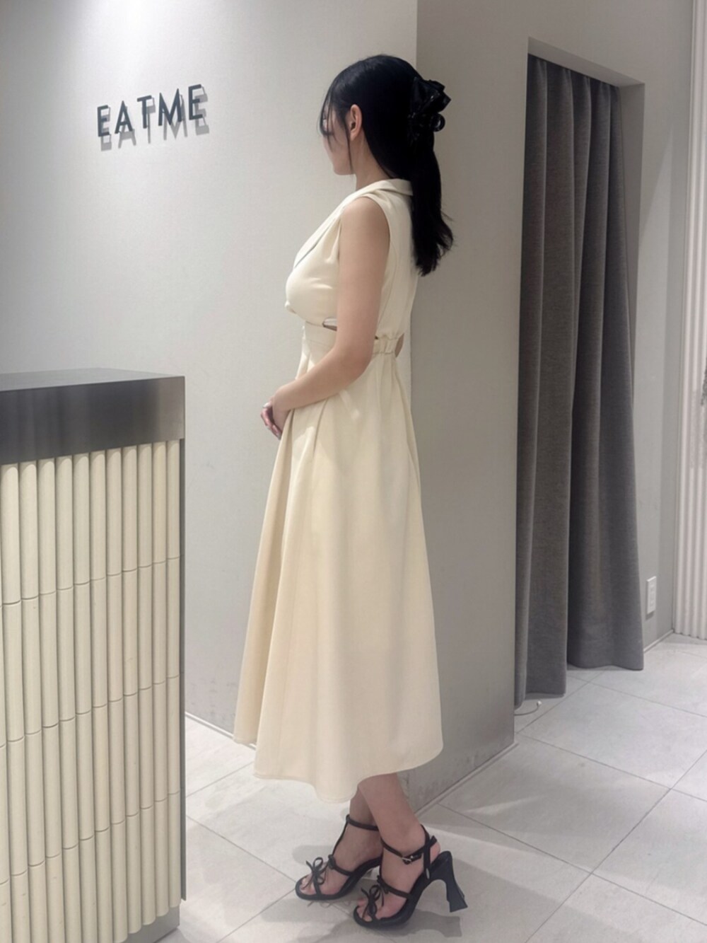 ブラック系のサンダル、イエロー系のワンピースを着用したレディースの夏コーディネートの2枚目の写真