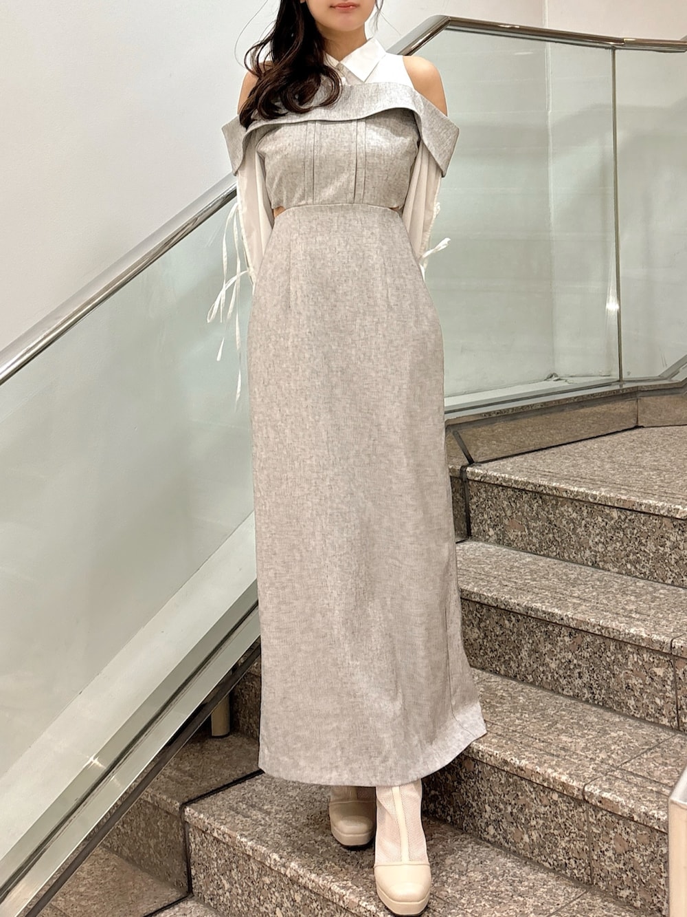 グレー系のワンピース、ベージュ系のブーツを着用したレディースの春コーディネートの5枚目の写真