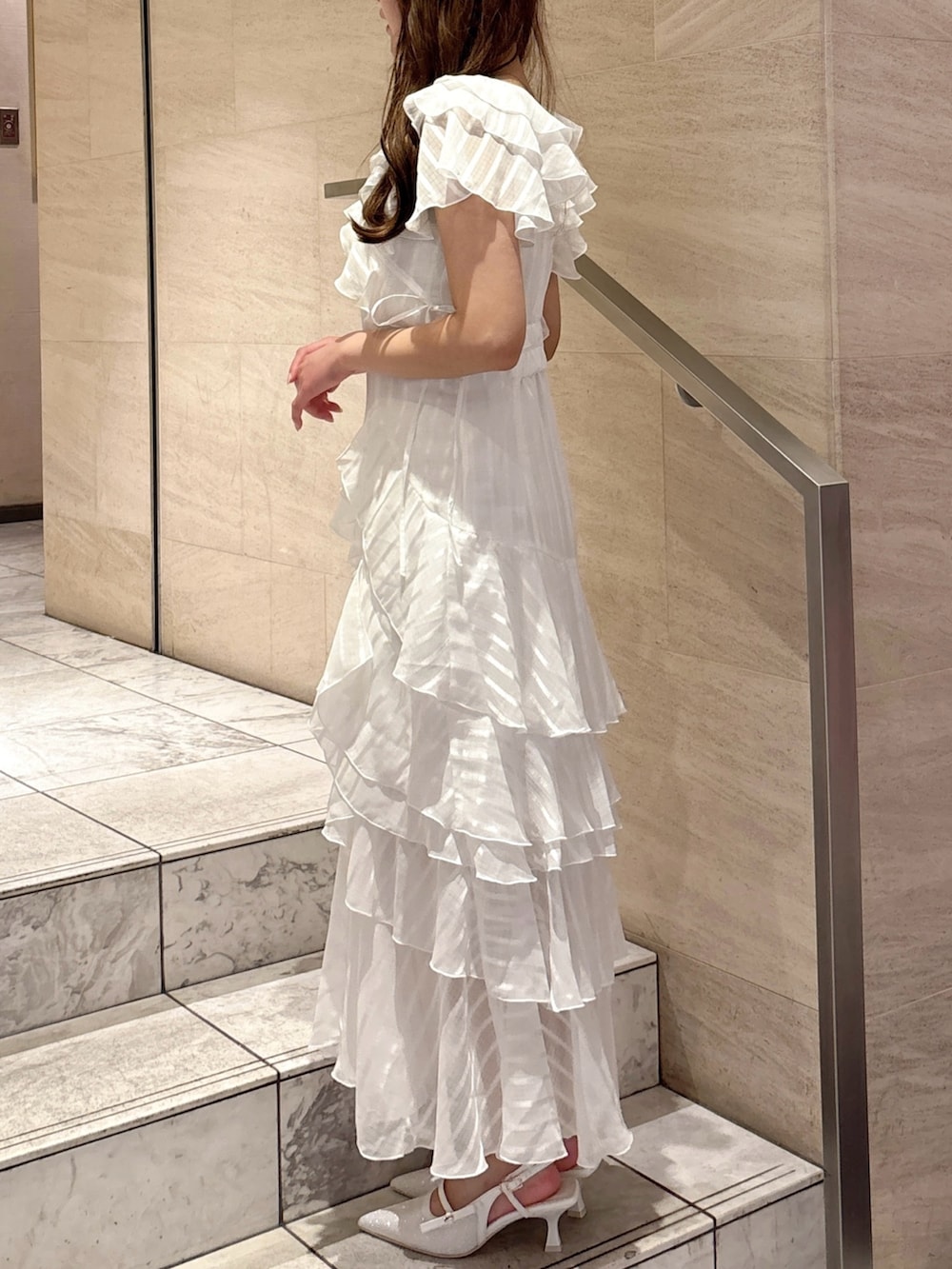 ホワイト系のワンピース、ホワイト系のパンプスを着用したレディースの春コーディネートの6枚目の写真