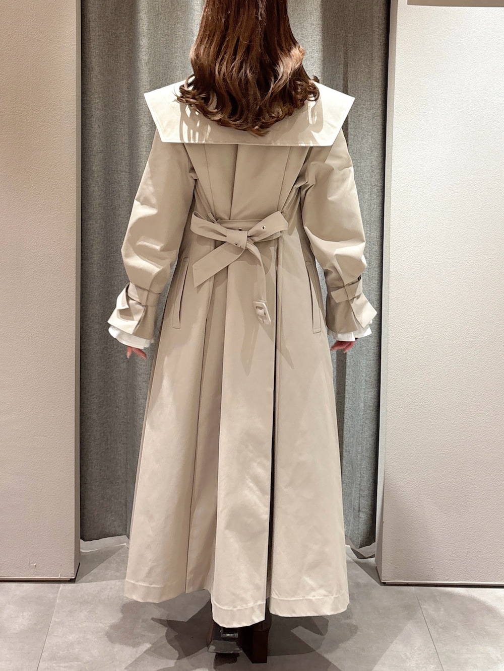 ブラック系のTシャツ/カットソー、ベージュ系のトレンチコート、グレー系のスカートを着用したレディースの春コーディネートの8枚目の写真