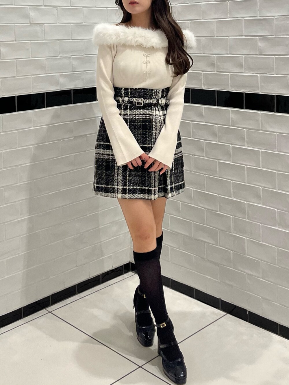 ベージュ系のニット/セーター、ブラック系のスカート、ブラック系のパンプスを着用したレディースの冬コーディネートの3枚目の写真