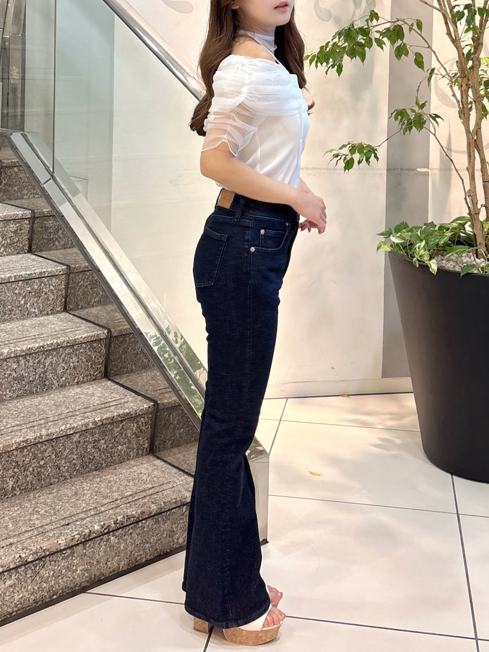 ホワイト系のTシャツ/カットソー、ブルー系のデニムパンツ、ホワイト系のサンダルを着用したレディースの夏コーディネートの5枚目の写真