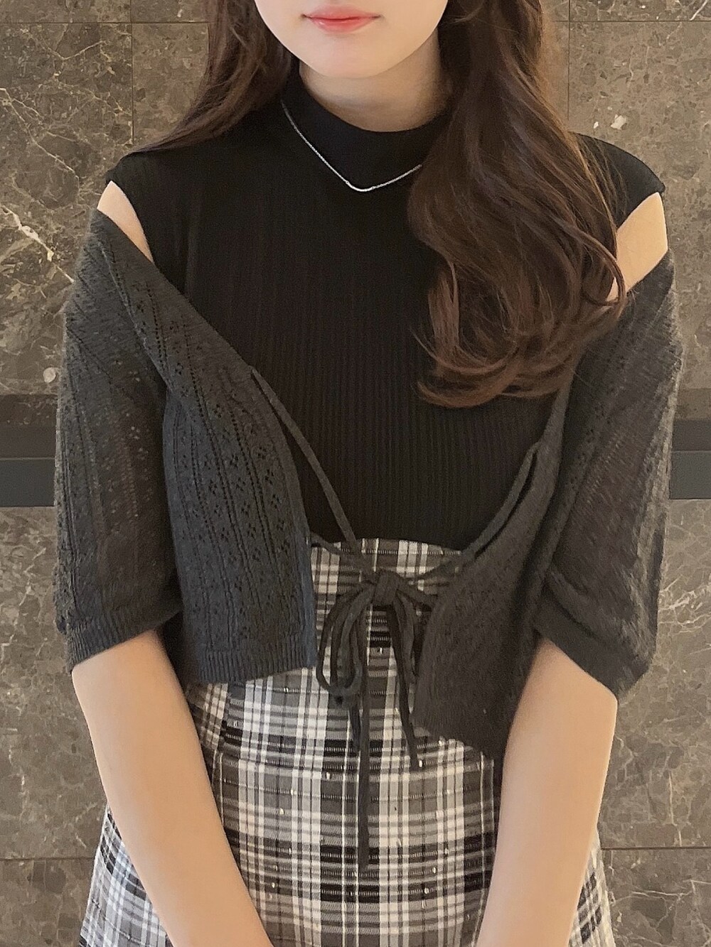 グレー系のニット/セーター、ブラック系のワンピース、ブラック系のパンプスを着用したレディースの夏コーディネートの4枚目の写真