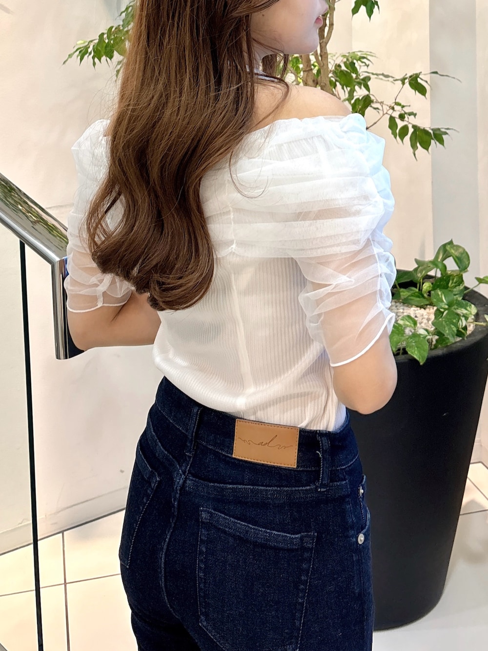 ホワイト系のTシャツ/カットソー、ブルー系のデニムパンツ、ホワイト系のサンダルを着用したレディースの夏コーディネートの9枚目の写真