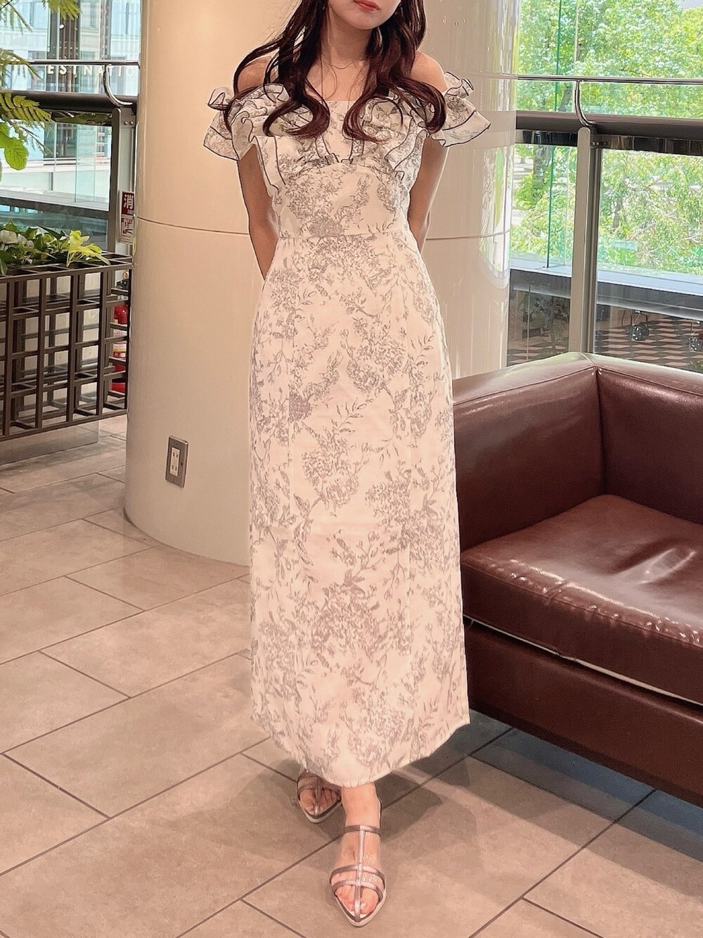 ホワイト系のワンピース、シルバー系のパンプスを着用したレディースの夏コーディネートの2枚目の写真