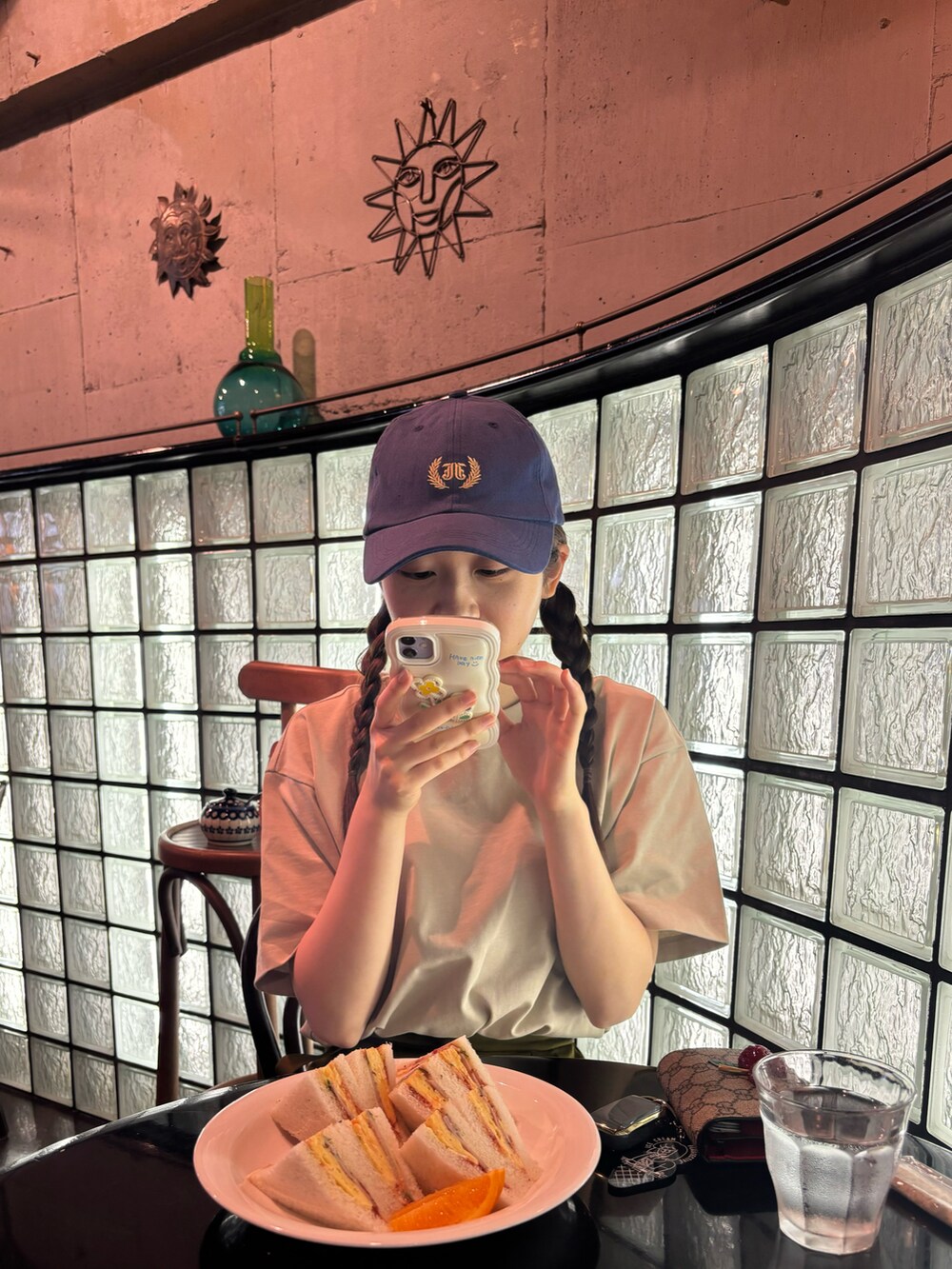 ベージュ系のTシャツ/カットソー、グリーン系のスカート、ブラック系のサンダルを着用したレディースの春コーディネートの3枚目の写真