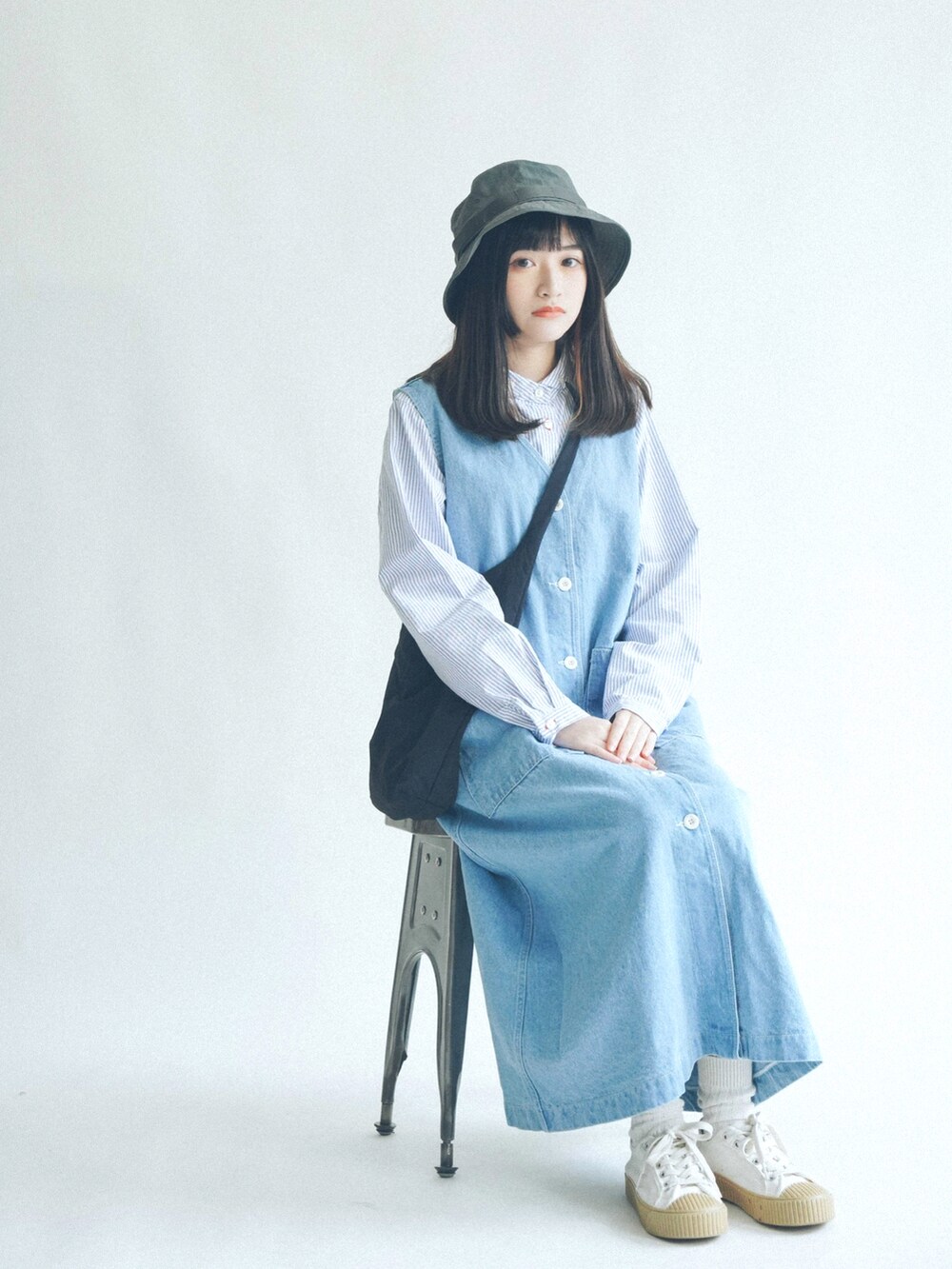 ブルー系のデニムスカートを着用したレディースの春コーディネートの3枚目の写真