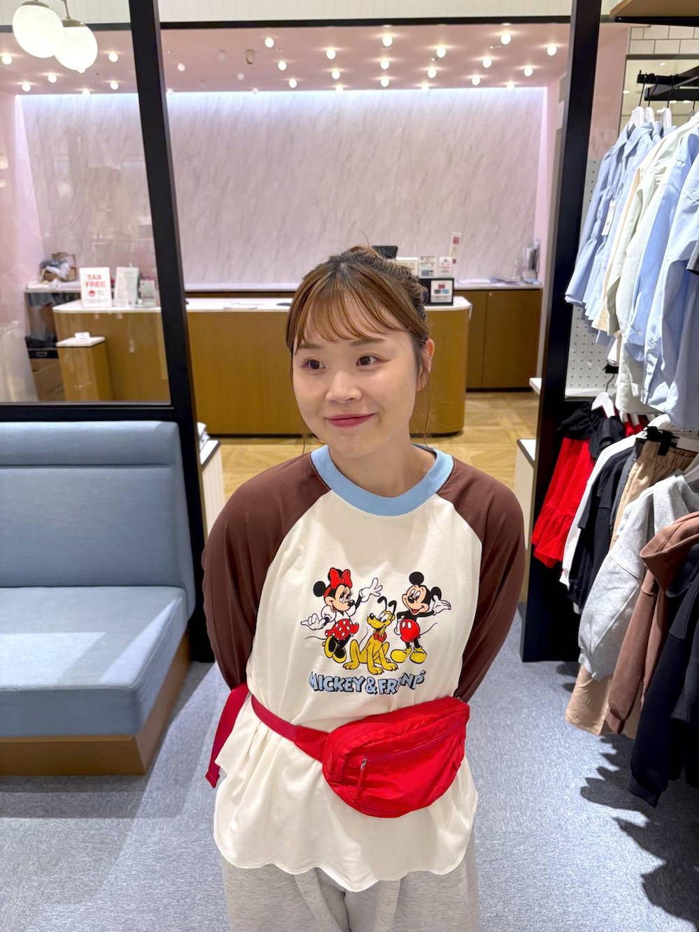 ベージュ系のTシャツ/カットソー、グレー系のスウェットパンツ、レッド系のボディバッグ/ウエストポーチを着用したレディースの秋コーディネートの2枚目の写真