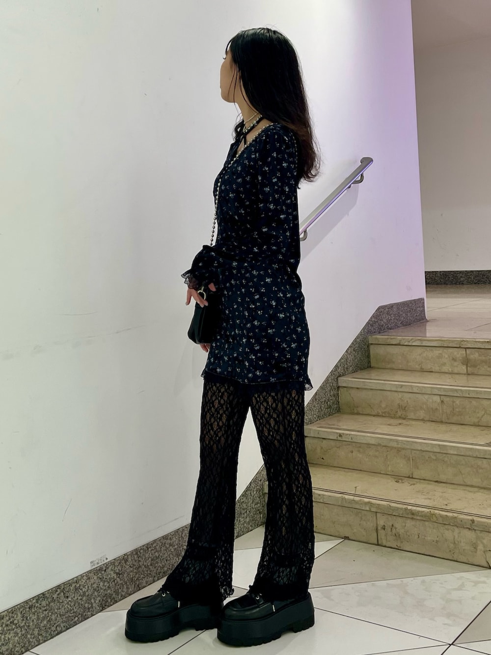 ブルー系のワンピース、ブラック系のハンドバッグ、ブラック系のその他パンツを着用したレディースの冬コーディネートの2枚目の写真