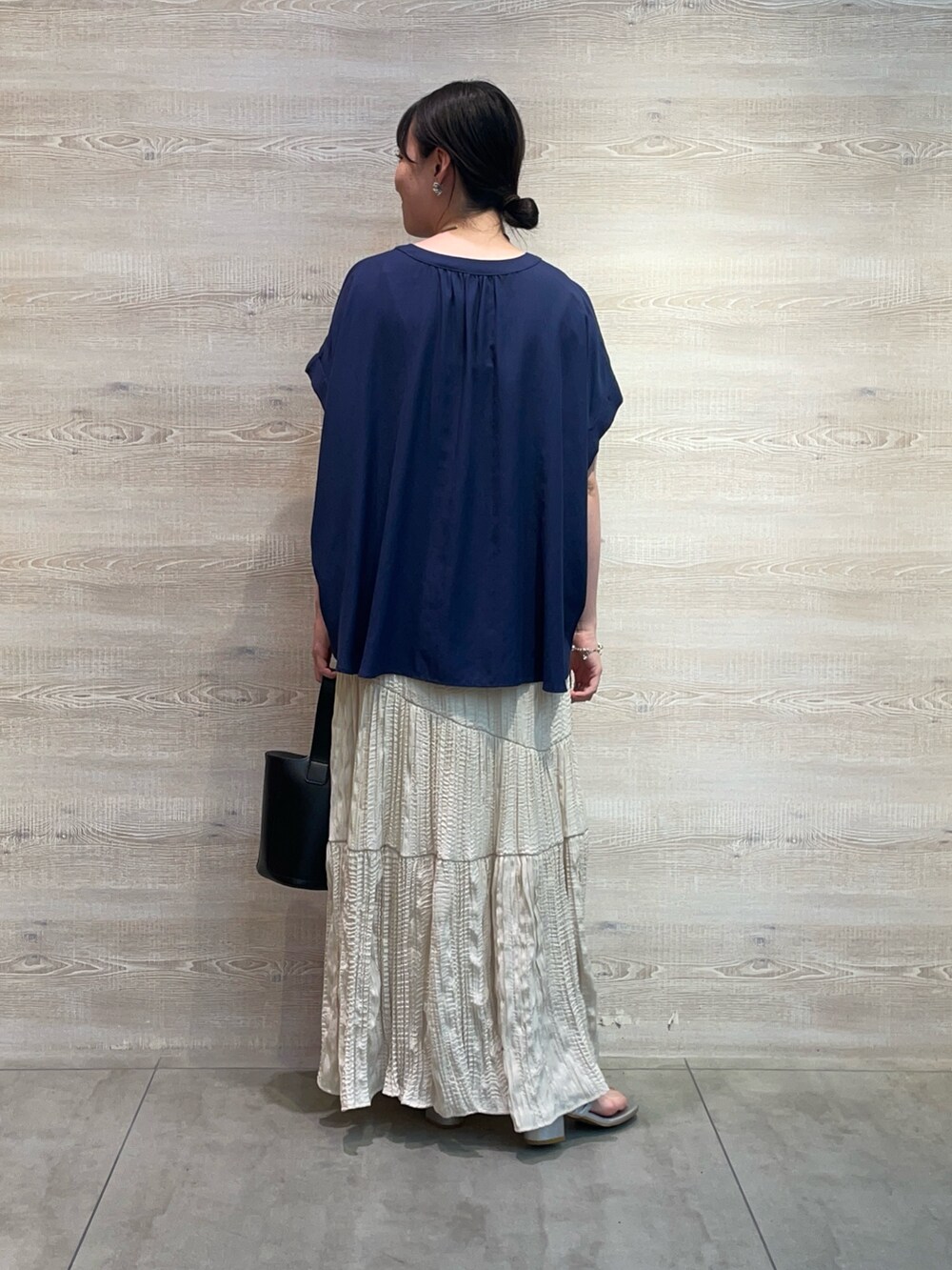 ブルー系のシャツ/ブラウス、ホワイト系のスカート、シルバー系のサンダルを着用したレディースの夏コーディネートの2枚目の写真