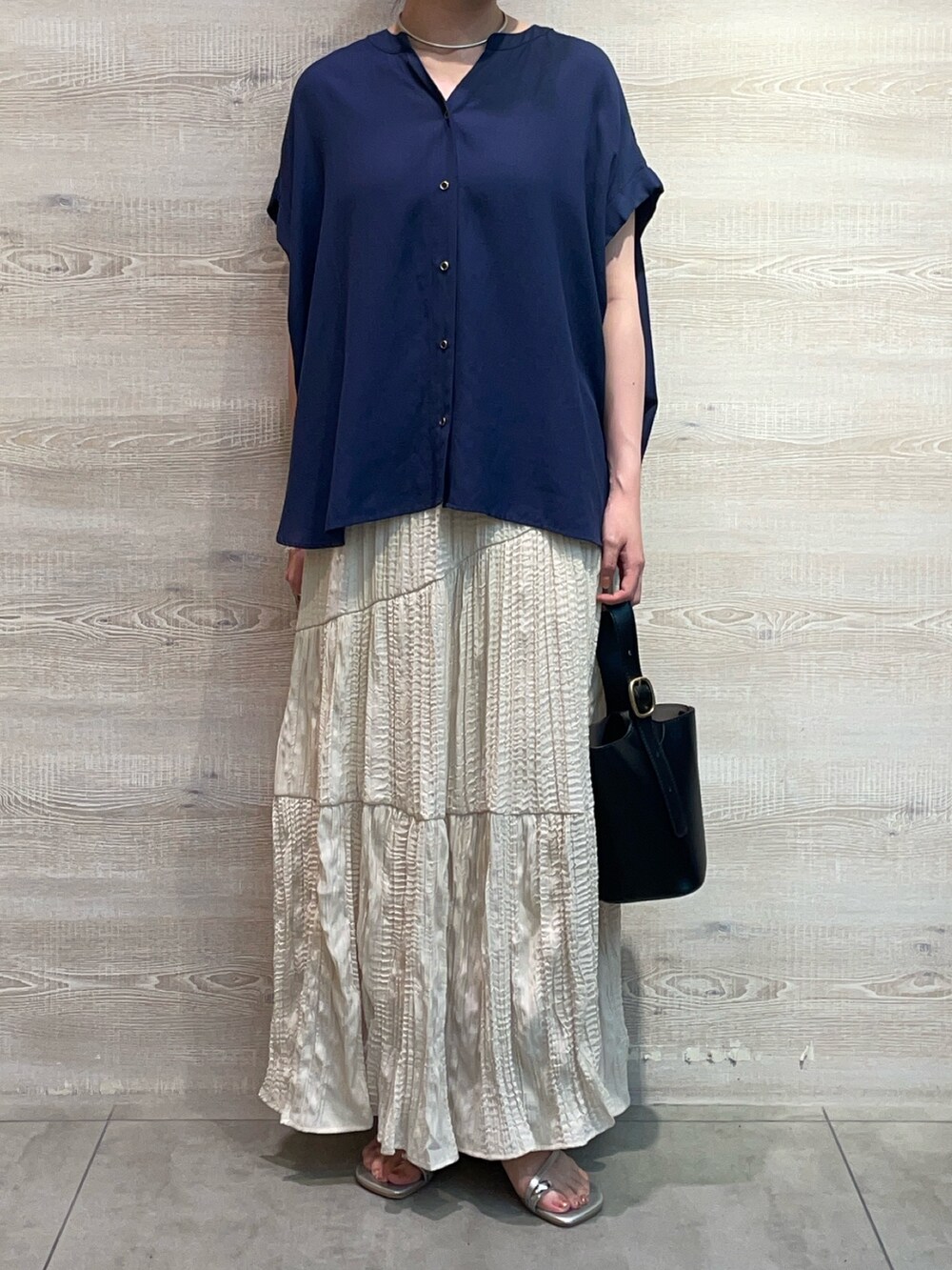 ブルー系のシャツ/ブラウス、ホワイト系のスカート、シルバー系のサンダルを着用したレディースの夏コーディネートの3枚目の写真