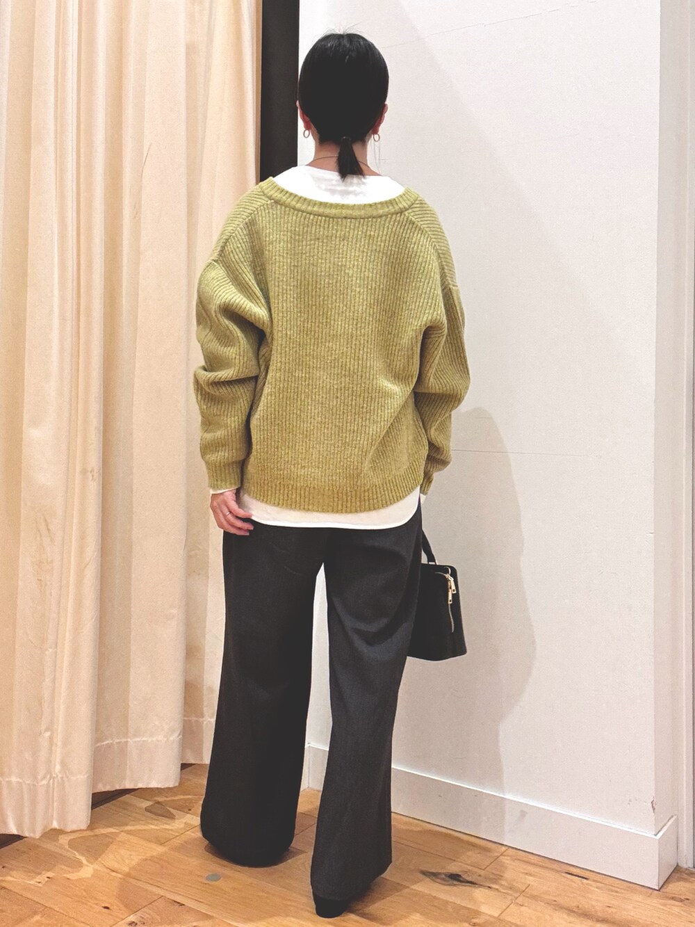 グリーン系のカーディガン/ボレロ、グレー系のその他パンツ、ホワイト系のTシャツ/カットソーを着用したレディースの秋コーディネートの3枚目の写真