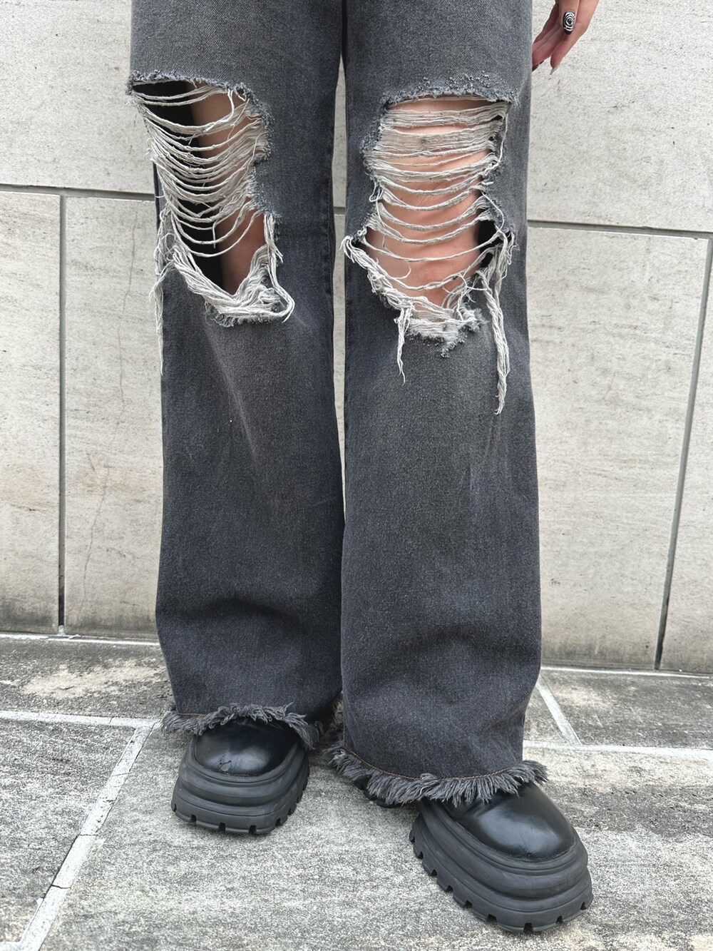 ブラック系のデニムジャケット、ブラック系のネクタイ、ブラック系のデニムパンツを着用したレディースの春コーディネートの4枚目の写真