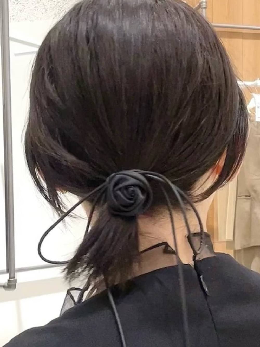 シルバー系のショルダーバッグ、ブラック系のパンプス、ブラック系のパンツドレスを着用したレディースの秋コーディネートの6枚目の写真