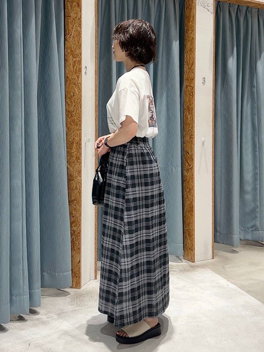 ホワイト系のTシャツ/カットソー、ホワイト系のサンダル、ブラック系のショルダーバッグを着用したレディースの夏コーディネートの5枚目の写真