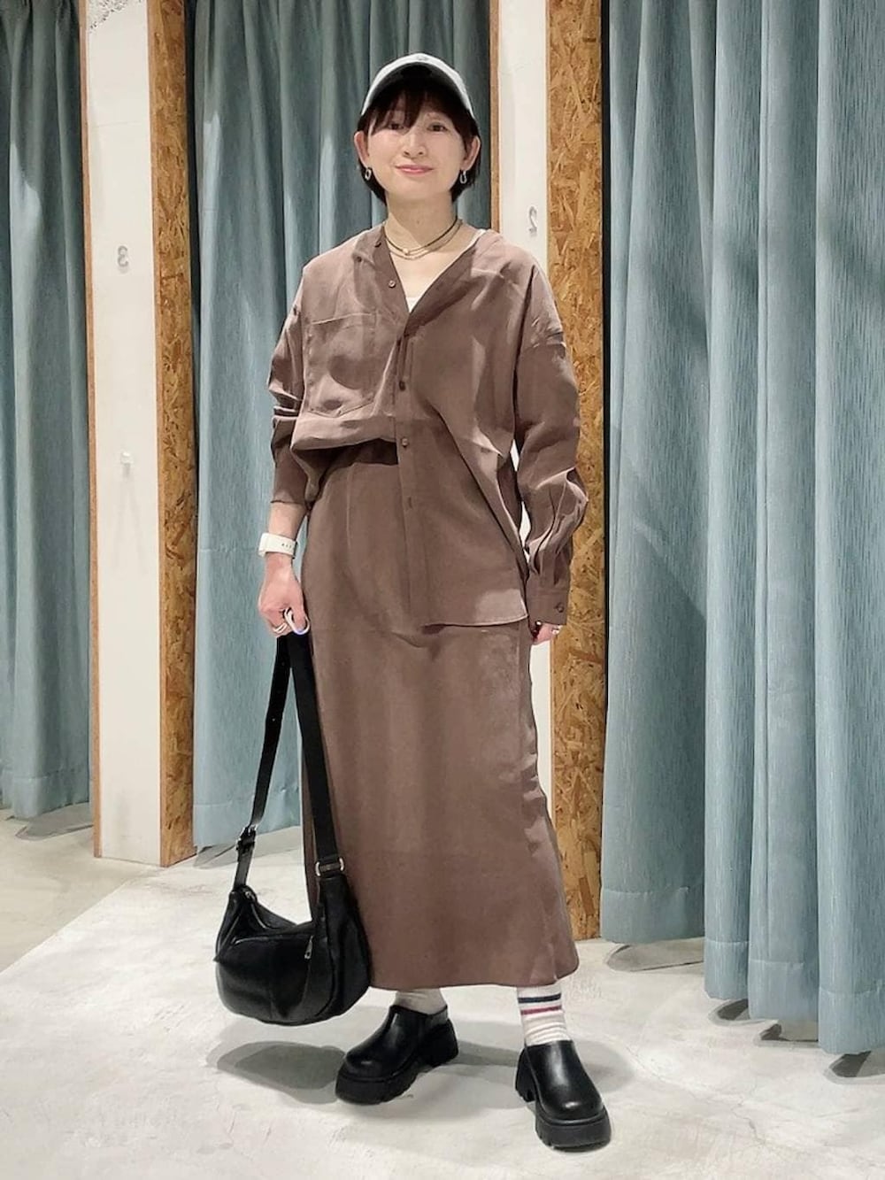 ブラック系のショルダーバッグ、ブラック系のその他シューズ、ブラウン系のシャツ/ブラウスを着用したレディースの春コーディネートの6枚目の写真