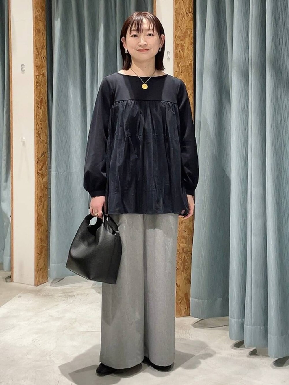 ブルー系のその他パンツ、ブラック系のショルダーバッグ、グレー系のその他パンツを着用したレディースの冬コーディネートの6枚目の写真