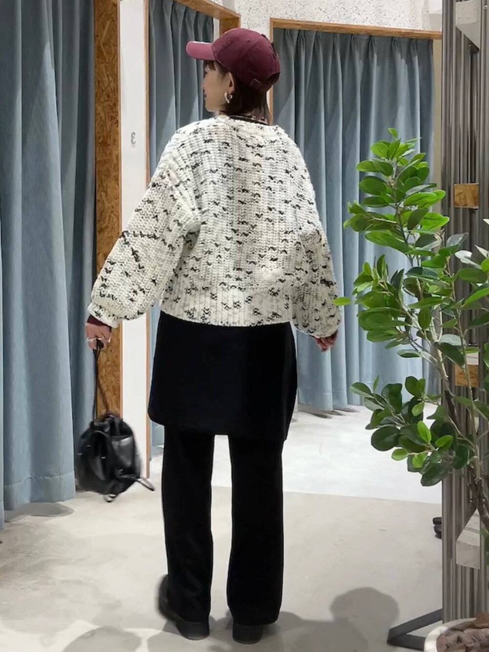 ブラック系のショルダーバッグ、ブラック系のその他パンツ、ホワイト系のニット/セーターを着用したレディースの秋コーディネートの6枚目の写真