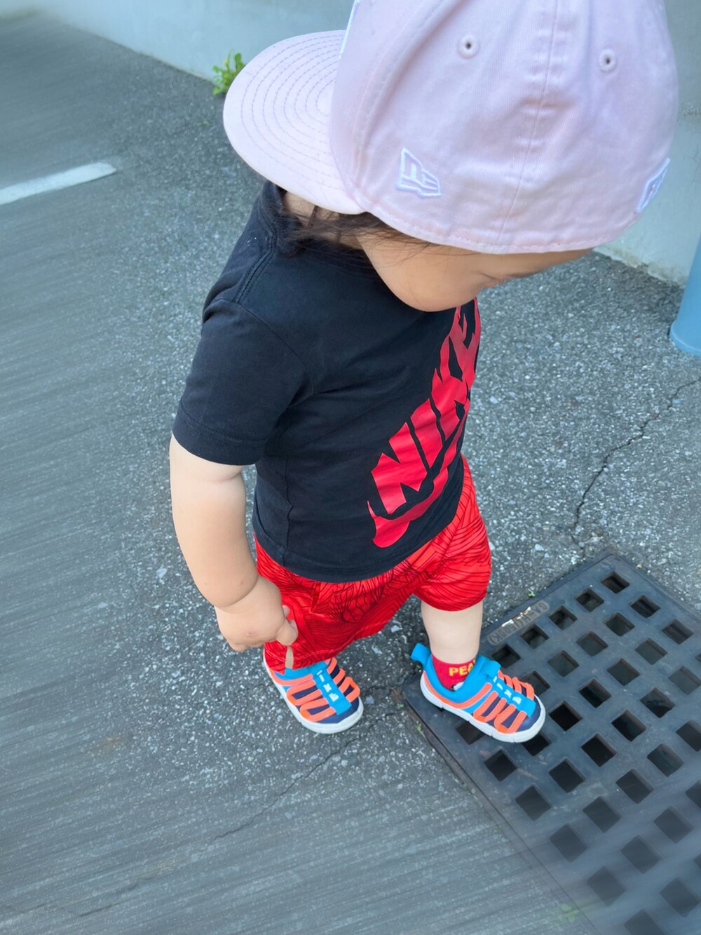 ブルー系のスニーカー、ブラック系のTシャツ/カットソー、レッド系のパンツを着用したキッズの夏コーディネートの3枚目の写真