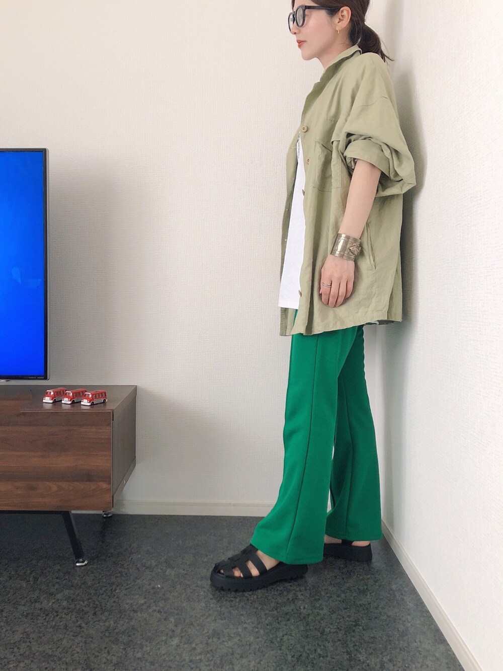 グリーン系のシャツ/ブラウス、ホワイト系のTシャツ/カットソー、ホワイト系のバッグを着用したレディースの春コーディネートの2枚目の写真