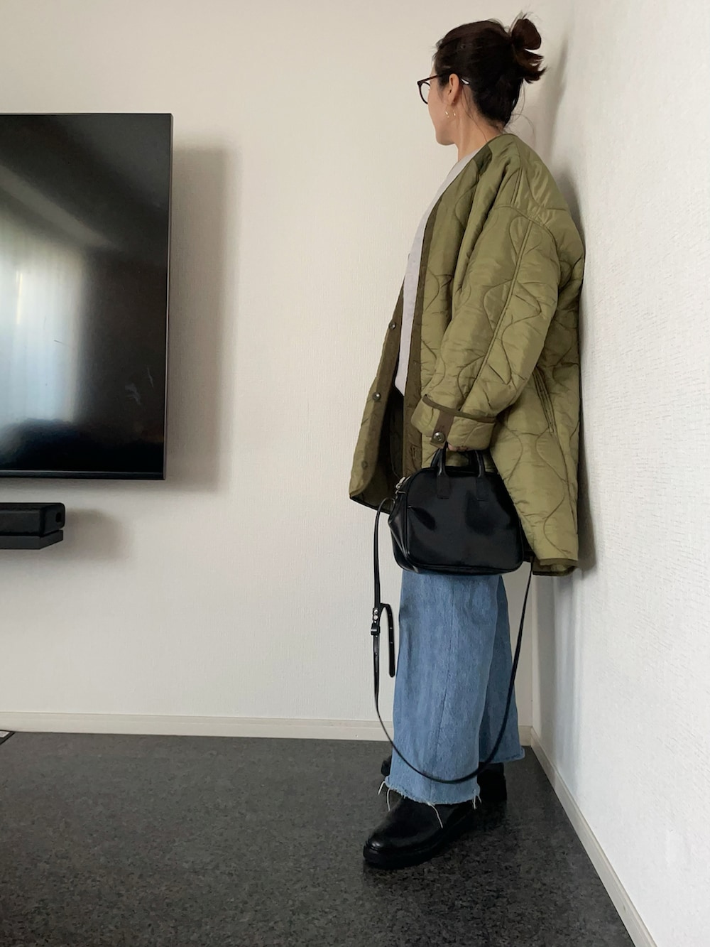 グレー系のニット/セーター、ホワイト系のTシャツ/カットソー、グリーン系のモッズコートを着用したレディースの秋コーディネートの2枚目の写真