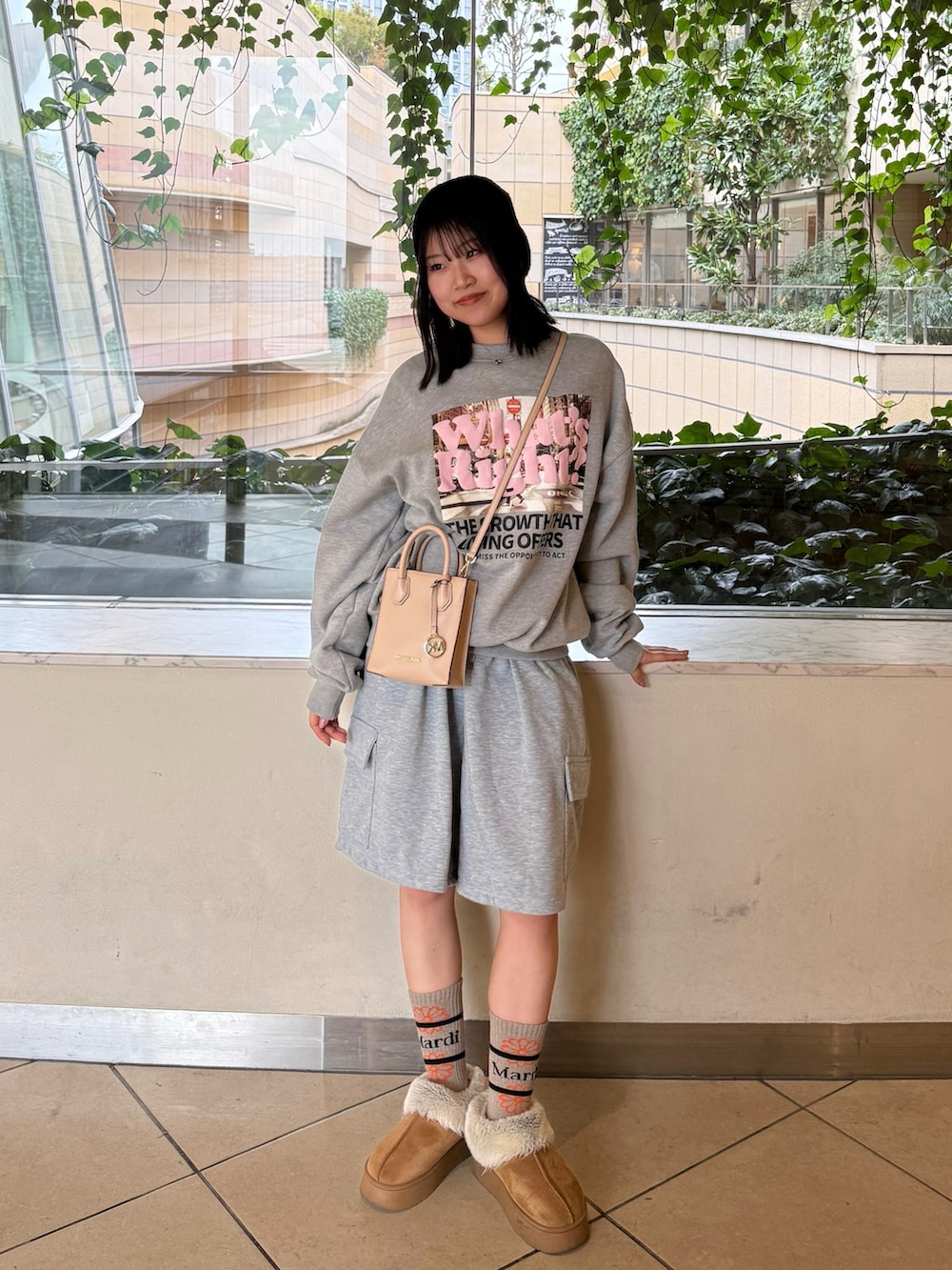 グレー系のスウェットパンツ、グレー系のスウェット、ベージュ系のショルダーバッグを着用したレディースの春コーディネートの2枚目の写真