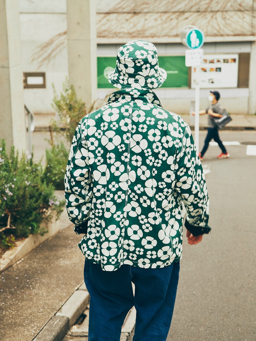 グリーン系のジャケット/アウター、グリーン系のスニーカー、グリーン系の帽子を着用したメンズの春コーディネートの3枚目の写真