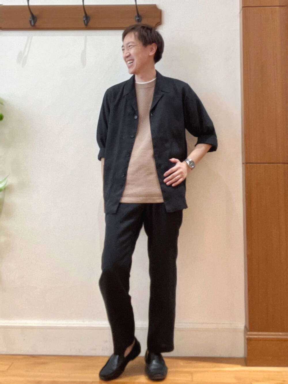 ブラック系のシャツ/ブラウス、ブラック系のその他パンツ、ベージュ系のニット/セーターを着用したメンズの春コーディネートの7枚目の写真