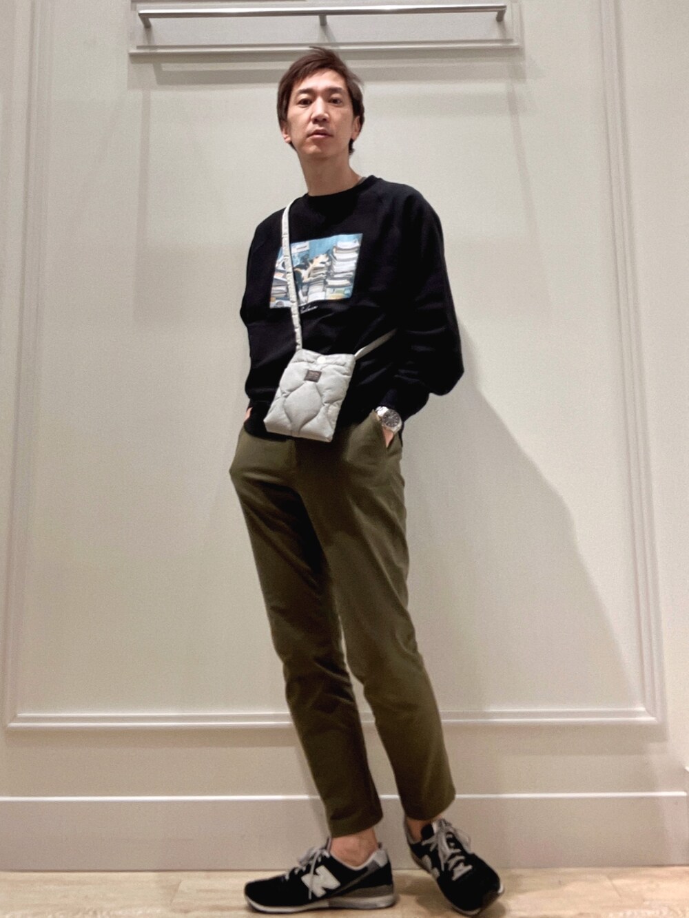 ブラック系のスウェット、グリーン系のショルダーバッグを着用したメンズの冬コーディネートの2枚目の写真