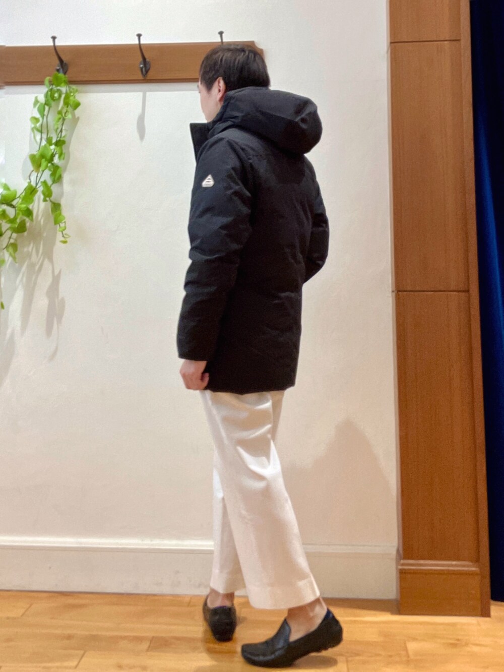 ホワイト系のTシャツ/カットソー、ブラック系のダウンジャケット/コート、ブルー系のカーディガン/ボレロを着用したメンズの冬コーディネートの3枚目の写真