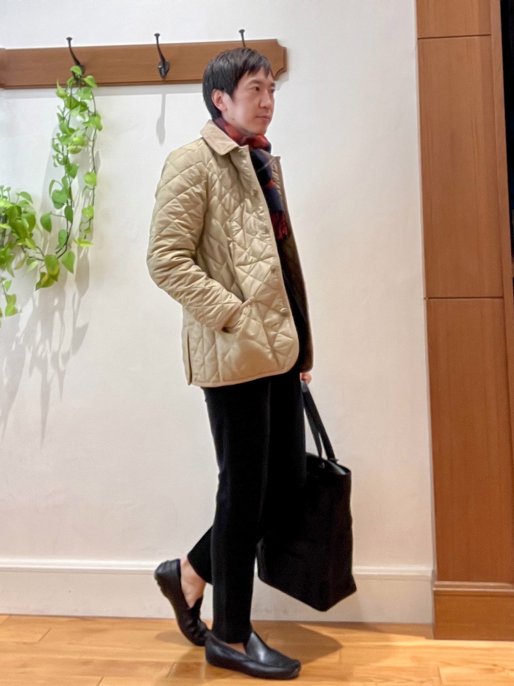 ブラック系のトートバッグ、ブラック系のその他パンツ、ホワイト系のTシャツ/カットソーを着用したメンズの秋コーディネートの6枚目の写真