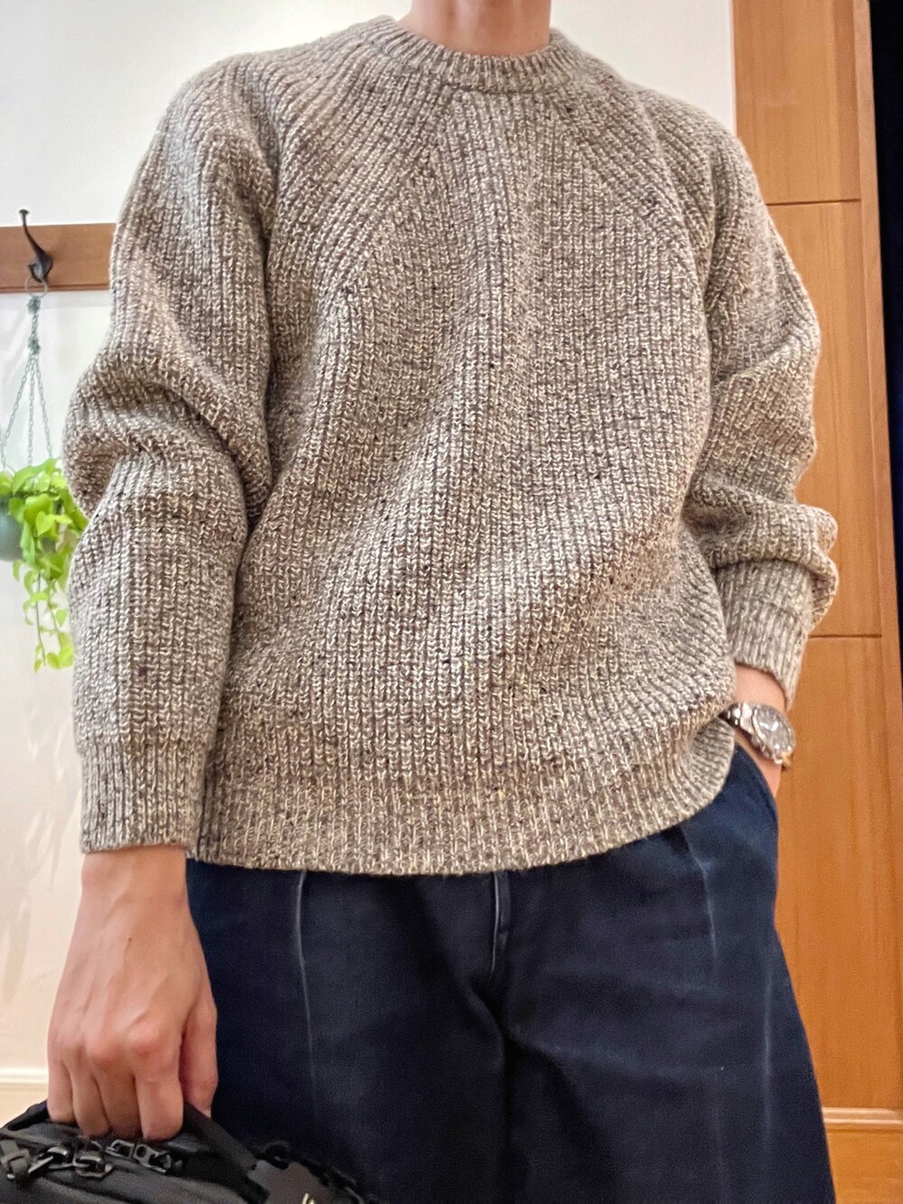 グレー系のニット/セーター、ブラック系のバックパック/リュックを着用したメンズの秋コーディネートの9枚目の写真