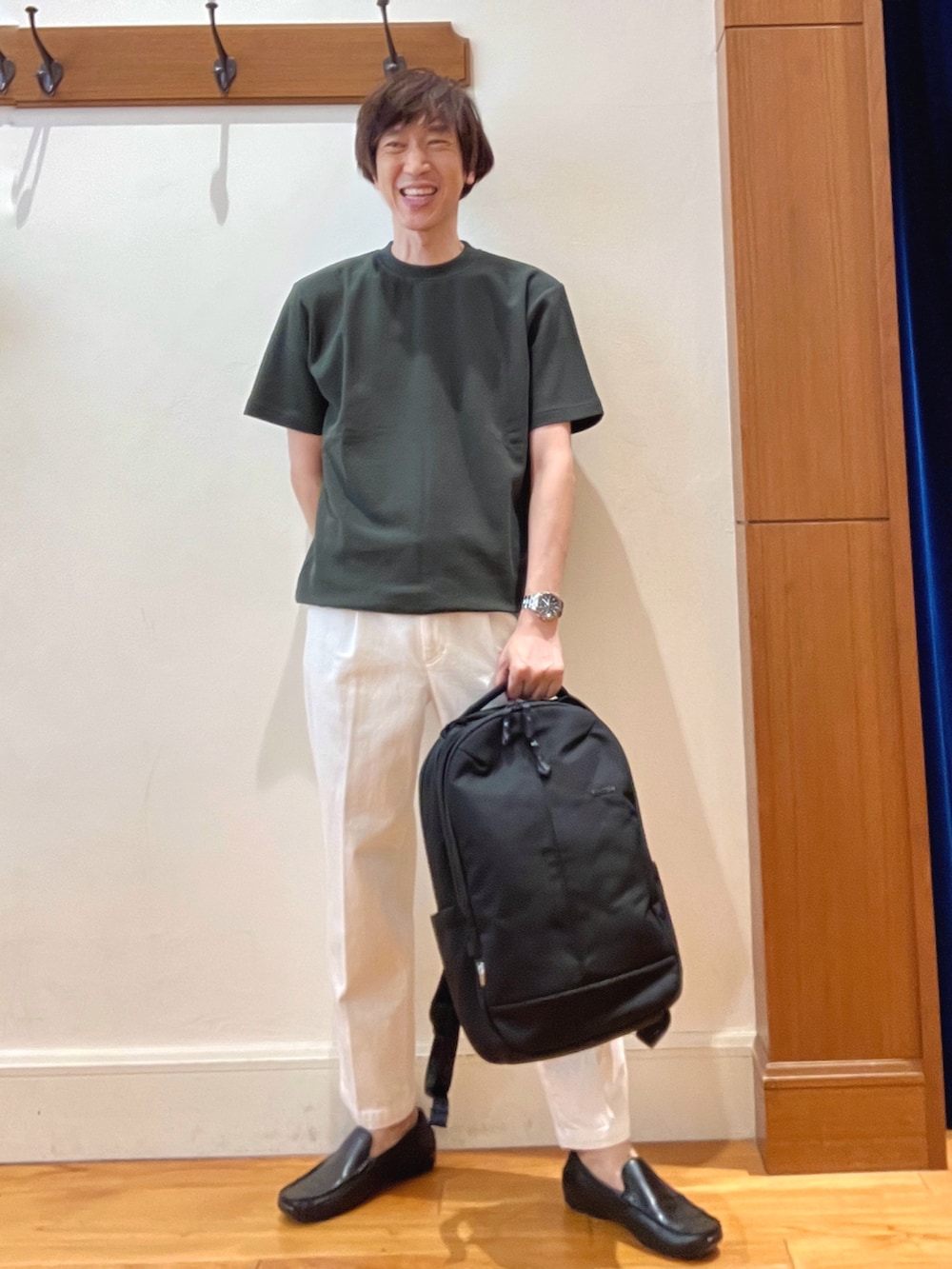 グリーン系のTシャツ/カットソー、グレー系のテーラードジャケット、ブラック系のバックパック/リュックを着用したメンズの夏コーディネートの9枚目の写真