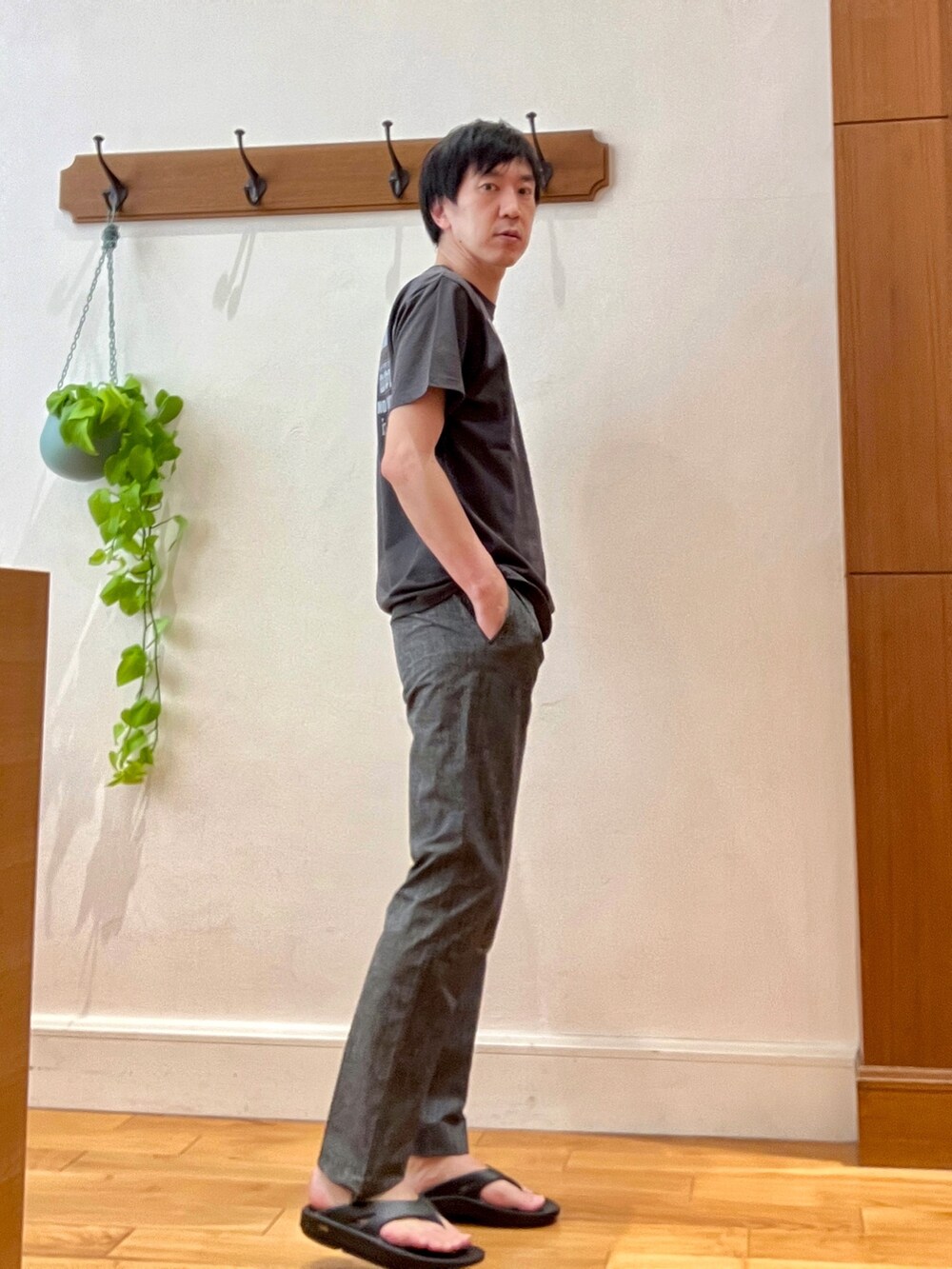 ブラック系のTシャツ/カットソー、グレー系のその他パンツ、ブラック系のサンダルを着用したメンズの春コーディネートの5枚目の写真