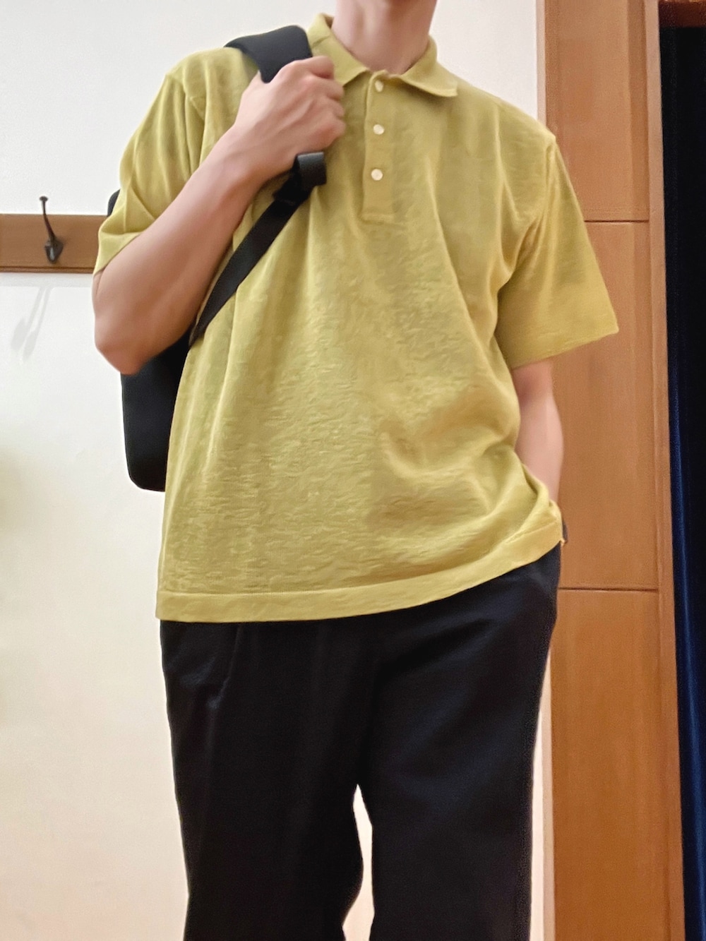 イエロー系のニット/セーター、ブルー系のその他パンツ、ブラック系のバックパック/リュックを着用したメンズの春コーディネートの6枚目の写真