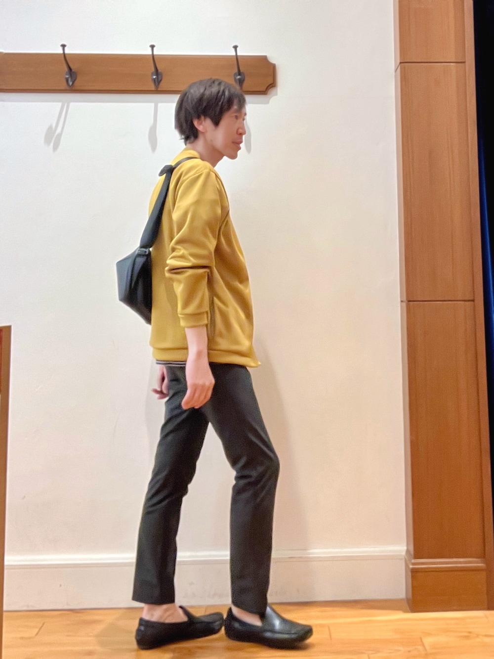 イエロー系のカーディガン/ボレロ、ブラック系のTシャツ/カットソー、ブラック系のショルダーバッグを着用したメンズの春コーディネートの6枚目の写真