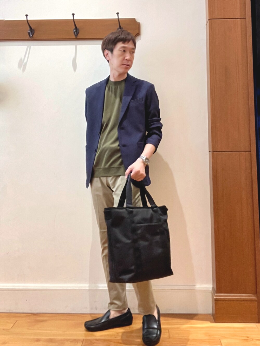 ブルー系のテーラードジャケット、グリーン系のTシャツ/カットソー、ベージュ系のチノパンツを着用したメンズの夏コーディネートの2枚目の写真
